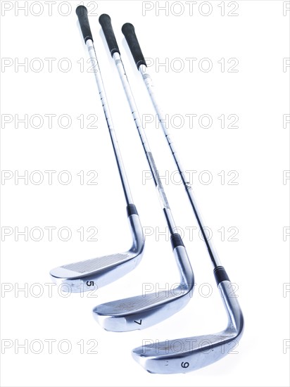 Three golf clubs on white background. Photo: David Arky