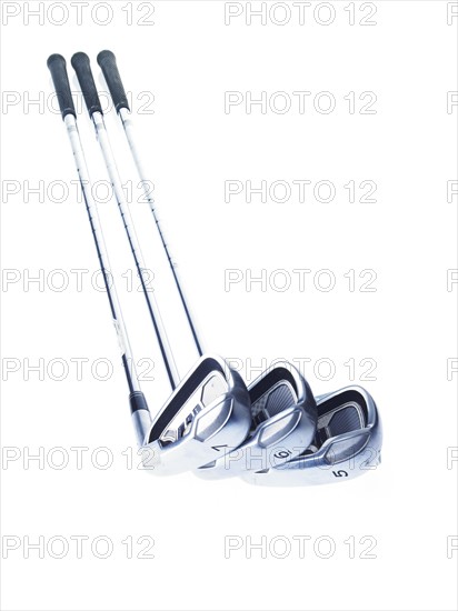 Three golf clubs on white background. Photo: David Arky