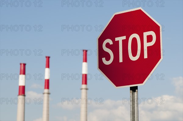 Stop sign with factory chimneys in background. Photo : Antonio M. Rosario