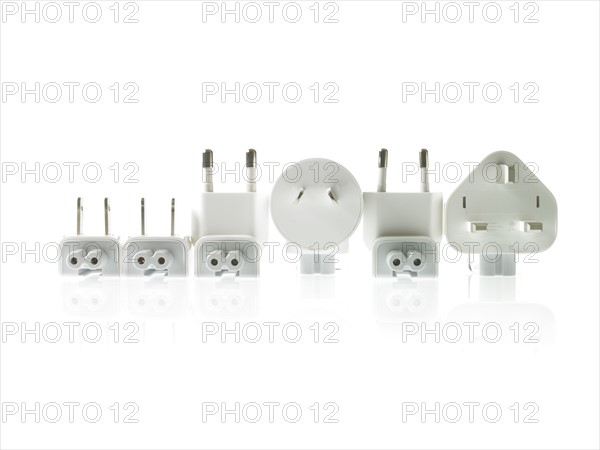 Row of plugs on white background. Photo : David Arky