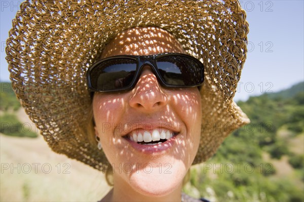 USA, California, Woman wearing straw hat. Photo: Noah Clayton