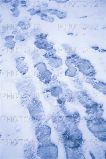 USA, New York City, Close-up view of footprints in snow. Photo : Kristin Lee