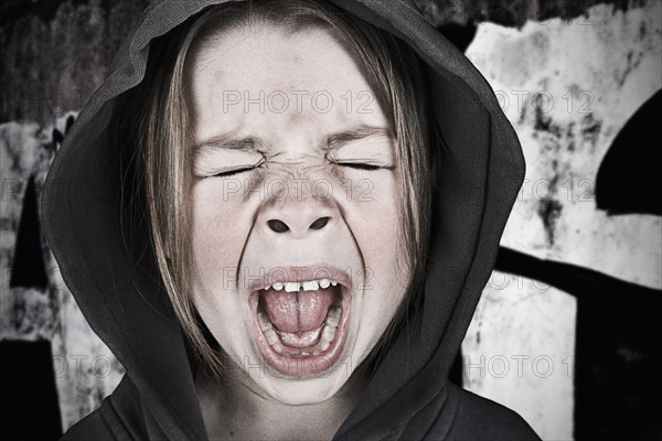 Close-up of girl (6-7) screaming. Photo : Justin Paget