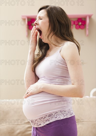 Young pregnant woman yawning. Photo : Mike Kemp