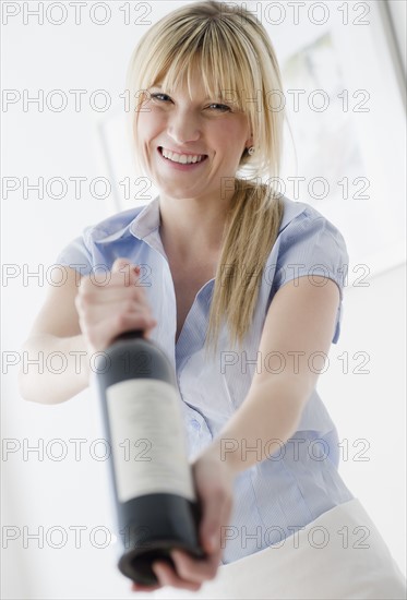 Waitress presenting wine. Photo : Jamie Grill Photography