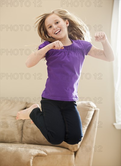 Portrait of girl (8-9) jumping. Photo : Mike Kemp