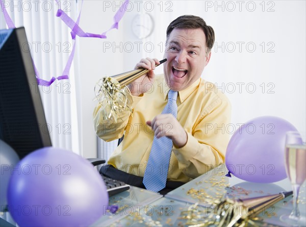 Businessman at office party. Photo: Jamie Grill Photography