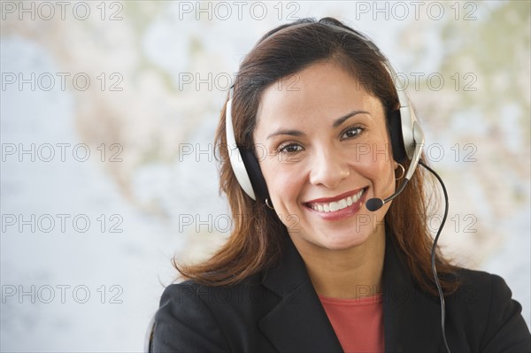 Smiling female customer service representative with headset.