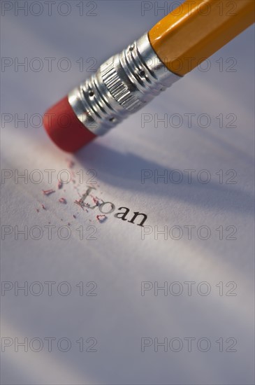 Studio shot of pencil erasing the word loan from piece of paper. Photo: Daniel Grill