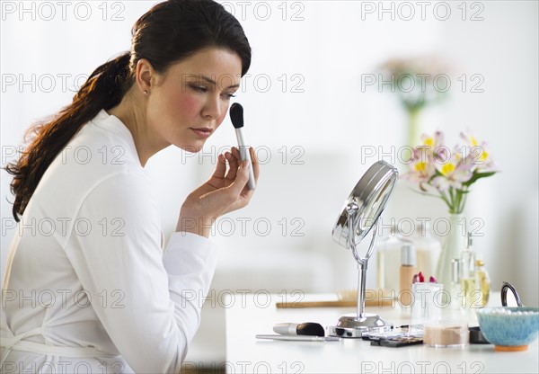 Woman doing make-up.