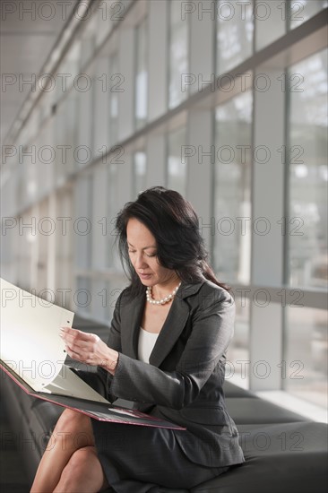 Businesswoman text-messaging. Photo : Mark Edward Atkinson