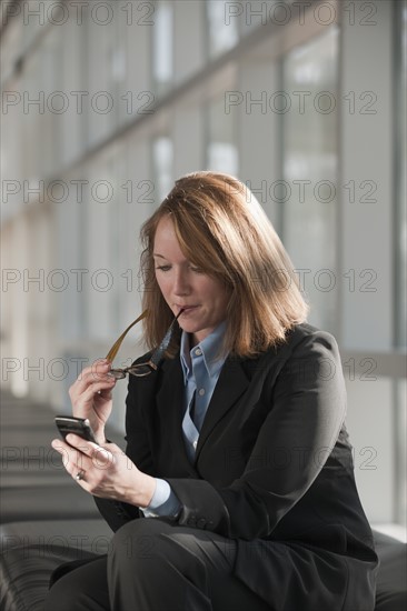 Businesswoman text-messaging. Photo: Mark Edward Atkinson