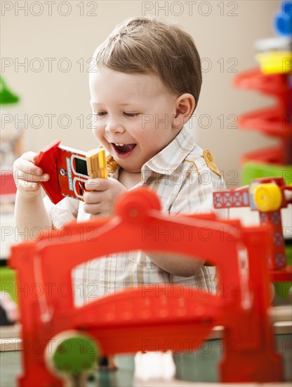 Boy (2-3) playing with colorful toys. Photo : Mike Kemp