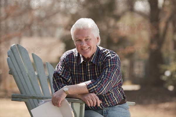 USA, Virginia, Richmond, portrait of senior man in adirondack chair. Photo : Mark Edward Atkinson