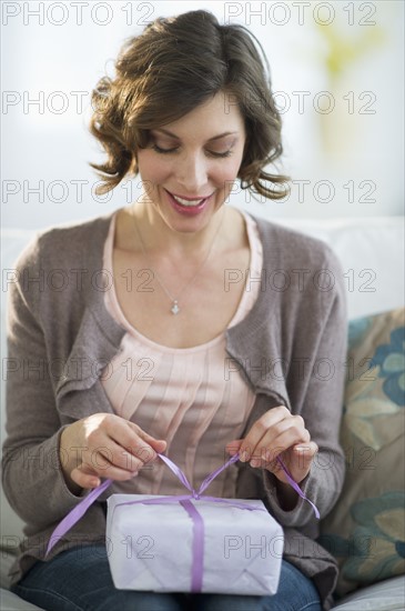 Woman wrapping gift.