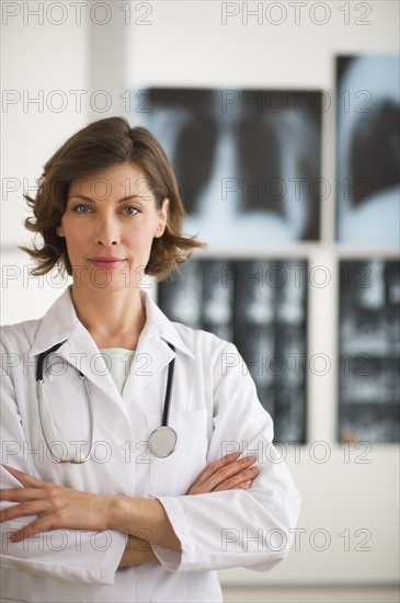 Portrait of doctor with x-ray images in background.