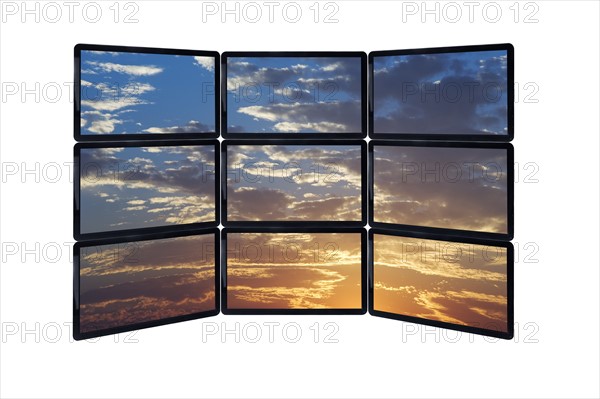 Close up of sky at sunset on monitors.