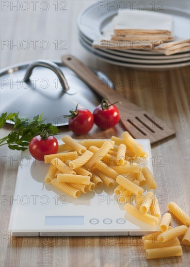 Raw pasta on weight scale.