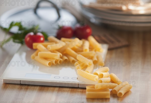 Raw pasta on weight scale.