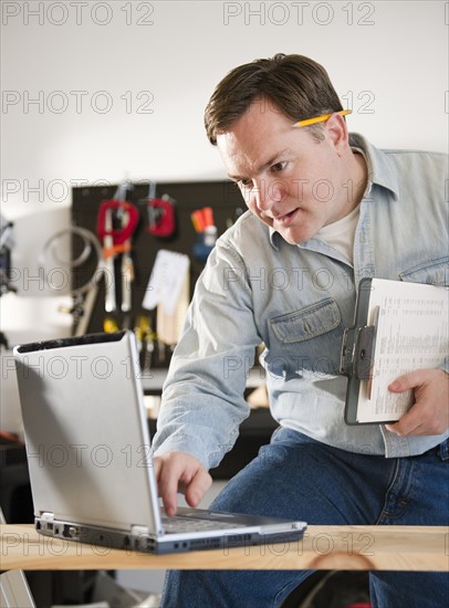 Man using laptop. Photo : Jamie Grill Photography