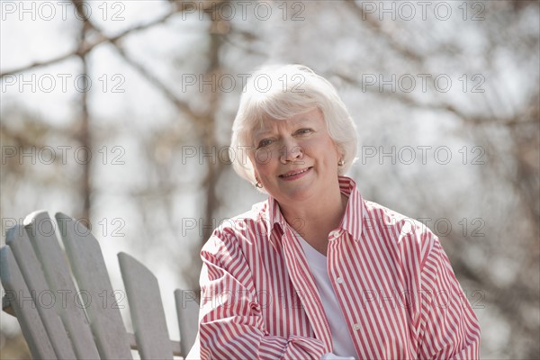 USA, Virginia, Richmond, portrait of senior woman in adirondack chair. Photo: Mark Edward Atkinson