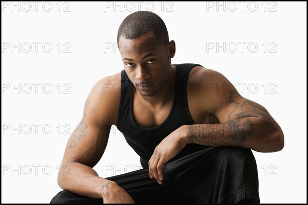 Studio shot of young man in sports clothing. Photo : Mike Kemp