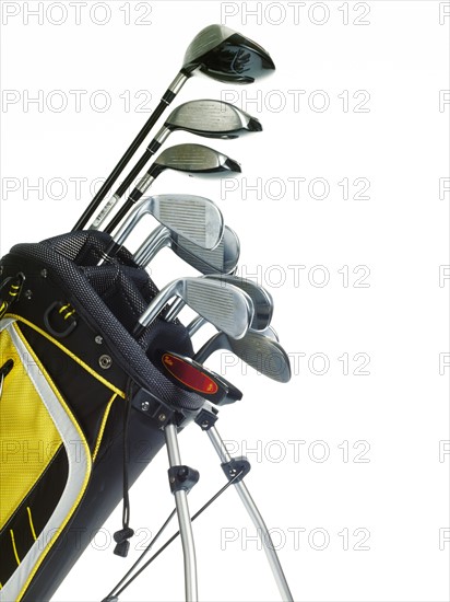 Golf bag with clubs on white background. Photo : David Arky