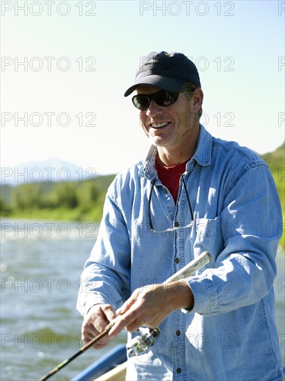 USA, Colorado, Mature man fly-fishing. Photo : John Kelly