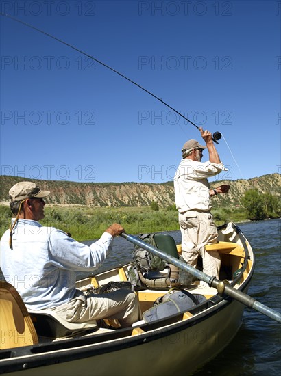 USA, Colorado, Pair of men fly-fishing on mountain river. Photo : John Kelly