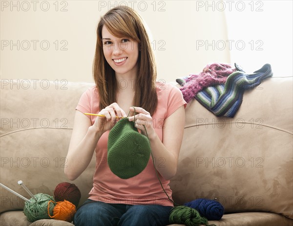 Young woman knitting woolly hat. Photo : Mike Kemp