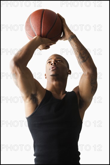 Studio shot of man playing basketball. Photo: Mike Kemp