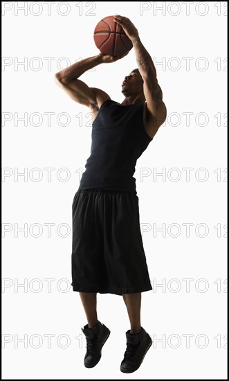 Studio shot of man playing basketball. Photo: Mike Kemp