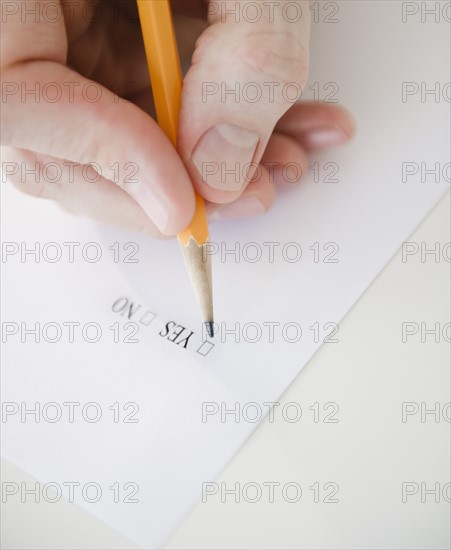 Hand filling document. Photo: Jamie Grill Photography