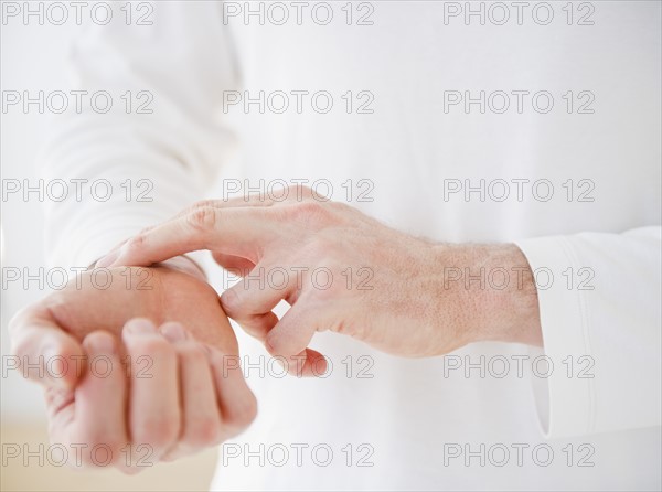 Hands taking pulse. Photo: Jamie Grill Photography