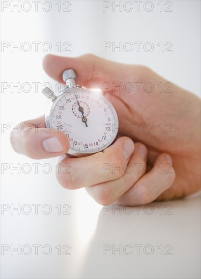 Hand holding stopwatch. Photo: Jamie Grill Photography