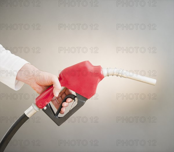 Hand holding fuel pump. Photo : Jamie Grill Photography