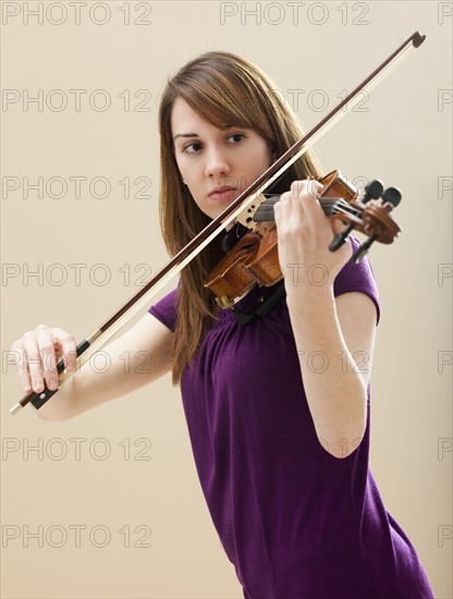 Young woman playing violin. Photo: Mike Kemp