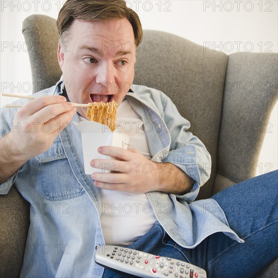 Man eating noodles. Photo : Jamie Grill Photography