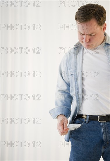 Man emptying pockets. Photo : Jamie Grill Photography