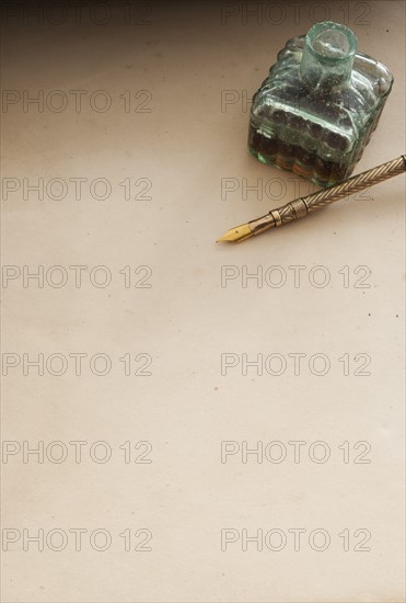 Close up antique ink well and pen.