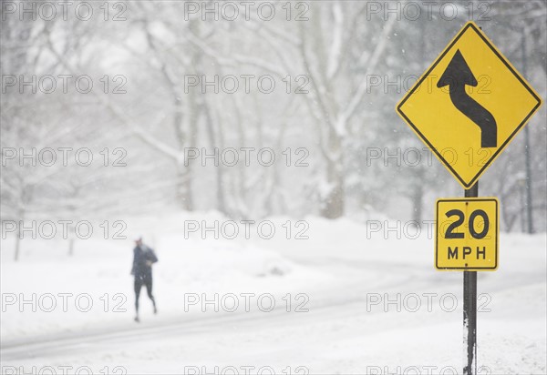 USA, New York City, speed limit and warning sign by snowy road. Photo : fotog