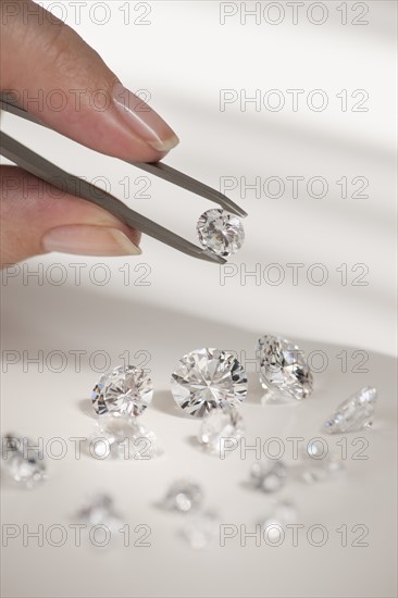 Studio shot of woman holding diamonds.