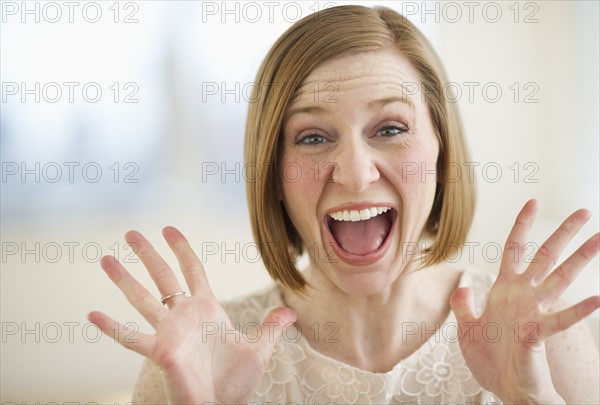 Portrait of excited woman screaming.