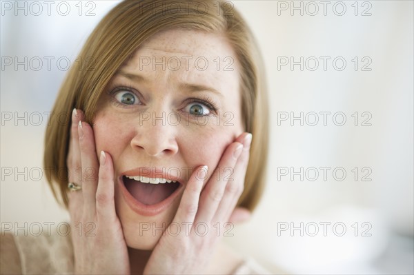 Portrait of shocked woman.