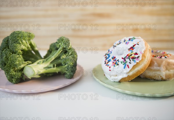 Donuts against broccoli. Photo : Jamie Grill Photography