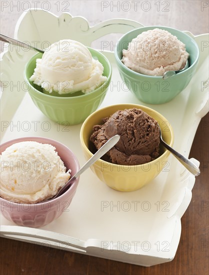 Close up of bowls with ice cream selection on tray.