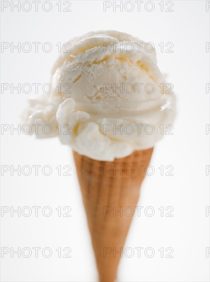 Close up of vanilla ice cream cone.