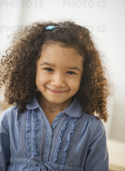 Portrait of smiling girl (6-7) with afro.