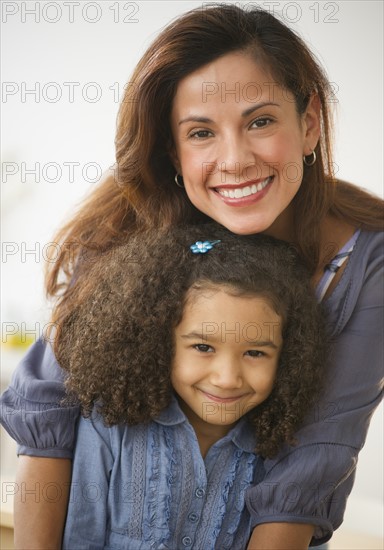Portrait of smiling mother and daughter (6-7).