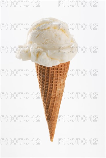 Close up of vanilla ice cream cone.